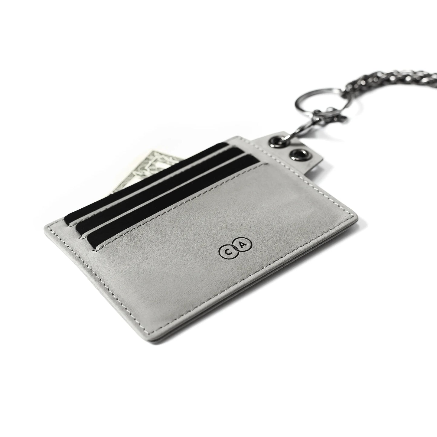 Closeup of suede card holder featuring debossed logo detailing and chain hook